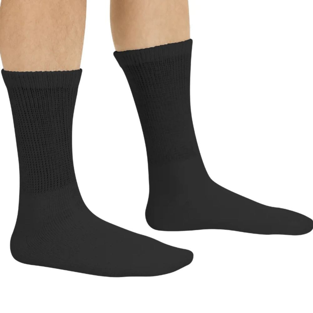 Black socks worn by a person on a white background