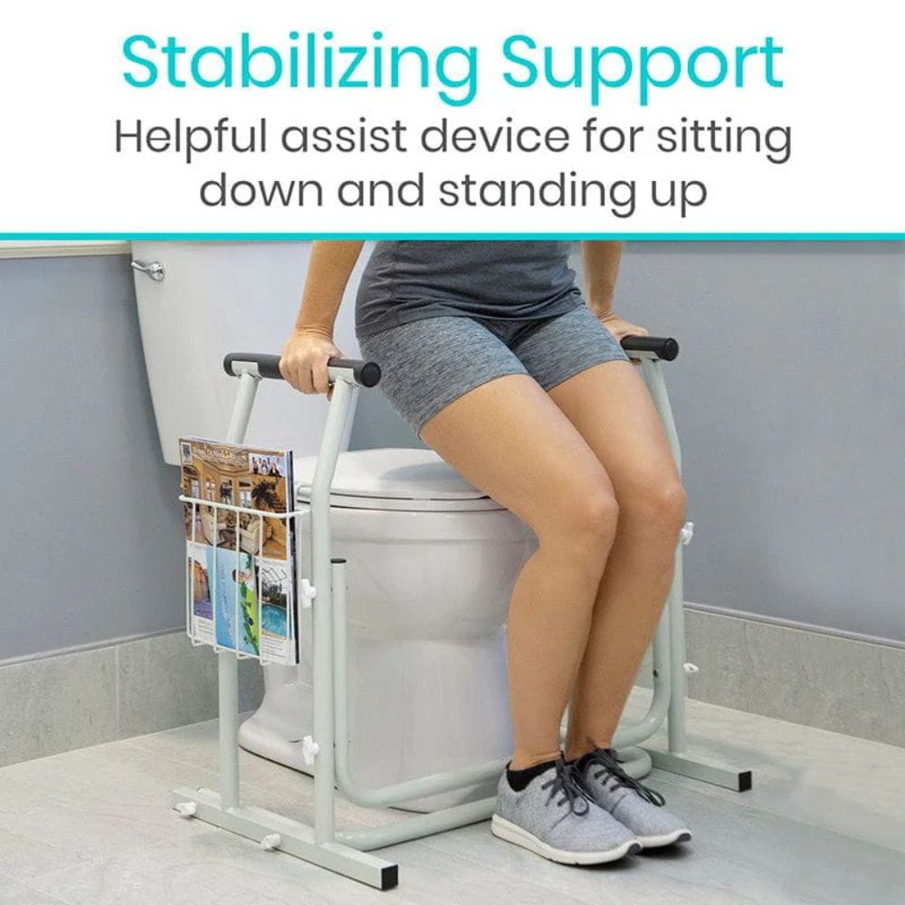 Person using a stabilizing support device while sitting on a toilet.