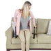 Woman sitting on a couch using a chair rail to elevate herself.