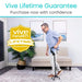 Man using a cane in a living room with 'Vive Health' lifetime guarantee badge.