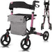 Pink and black rollator with gray bag on a white background