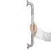 Hand holding a stainless steel grab bar against a white background