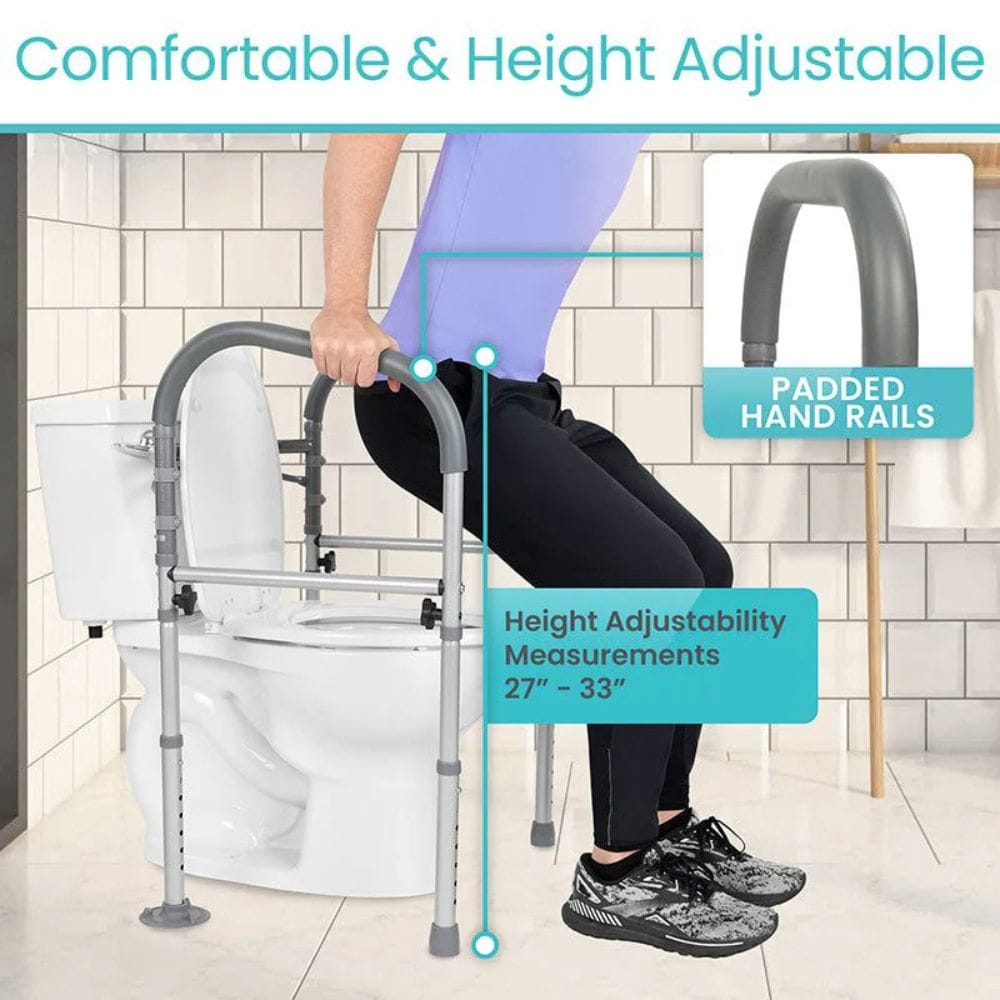 Person using a height-adjustable toilet safety frame with padded hand rails in a bathroom setting.