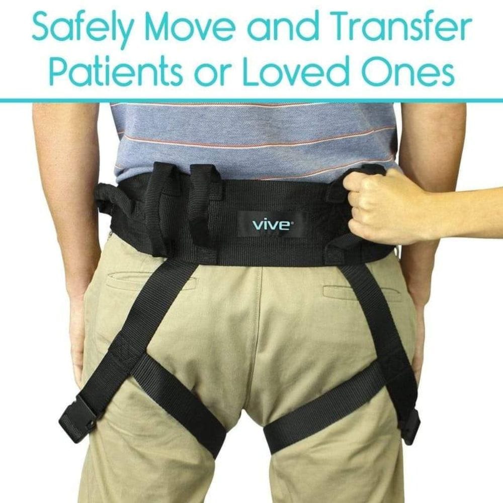Person wearing a black 'vive' patient transfer belt with text about safely moving patients.