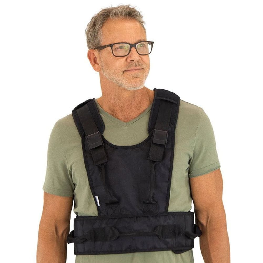 Man wearing a black weighted vest on a white background