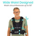 Man wearing a black vest with measurements displayed, on a white background