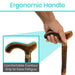 Hand holding a wooden walking cane with an ergonomic handle, emphasizing comfort and ease of use.