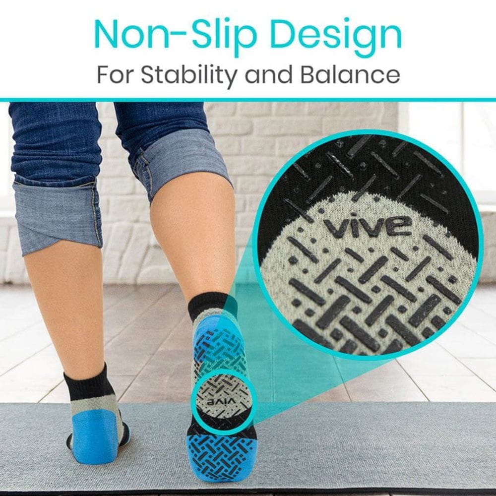 Person wearing blue socks with non-slip design on a mat, emphasizing stability and balance.