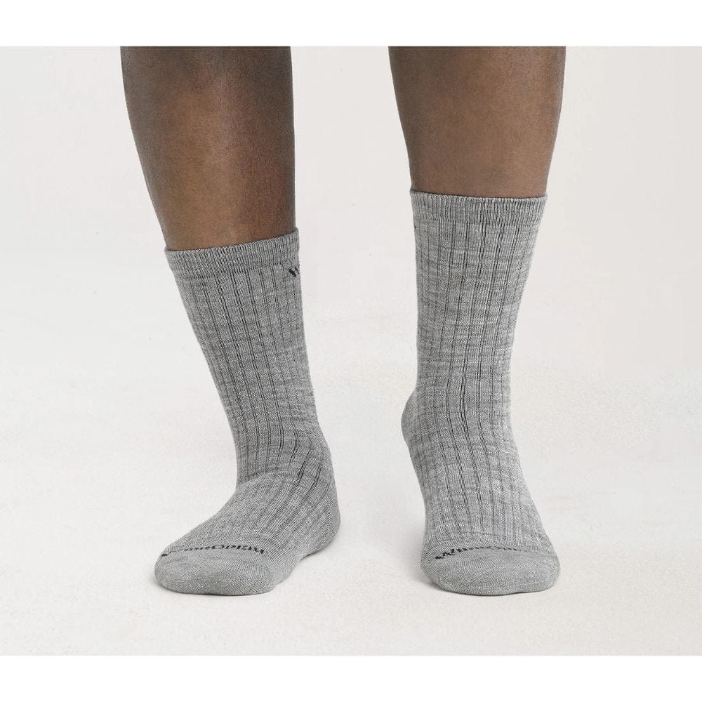 Gray socks worn by a person on a white background