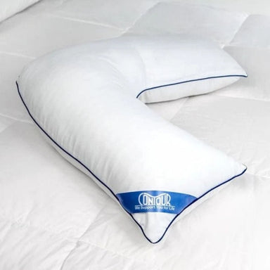 A white U-shaped cervical pillow with blue piping and a blue OnOur brand label, resting on a white quilted mattress.